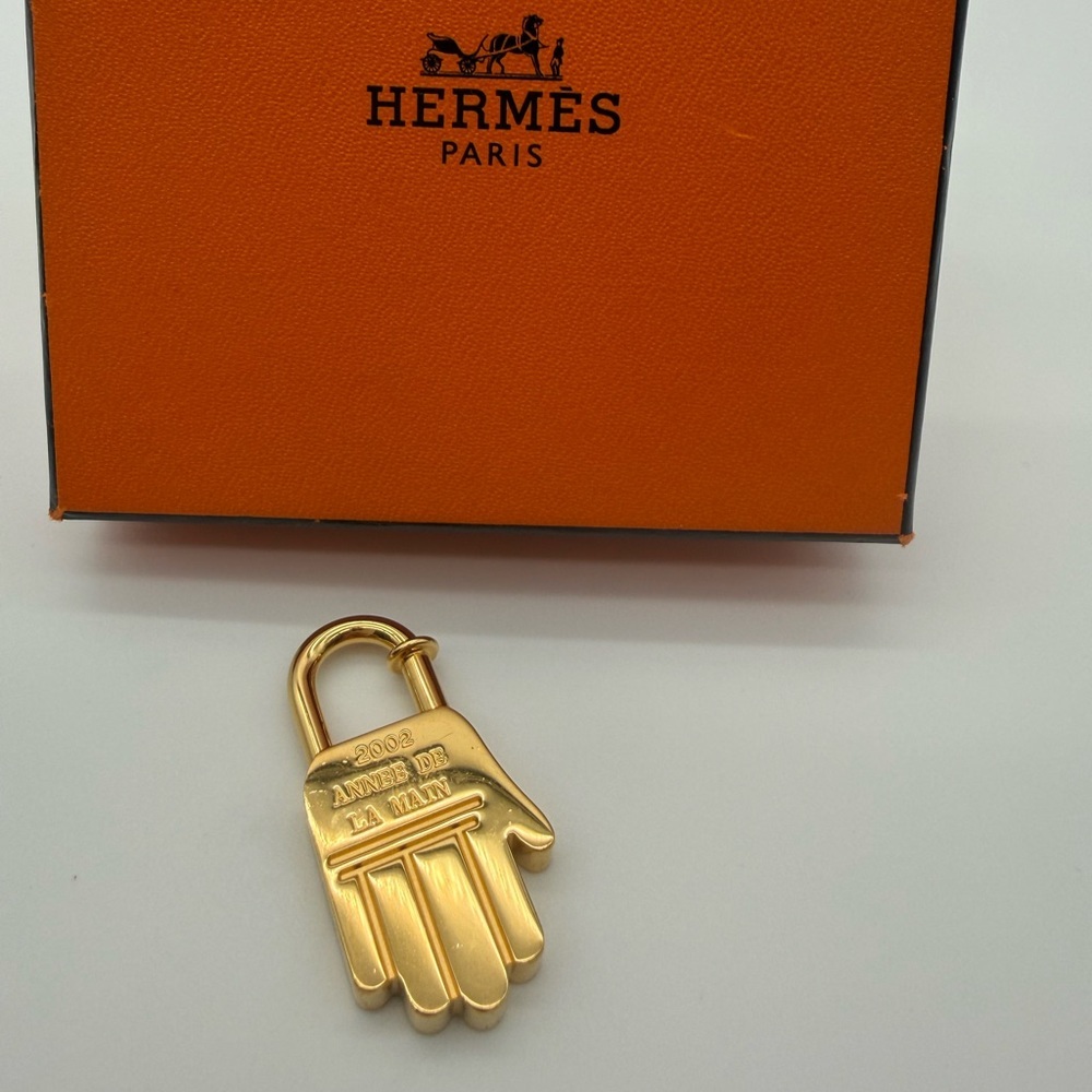 Hermès 2002 "Année de la Main" hand motif Cadena lock charm